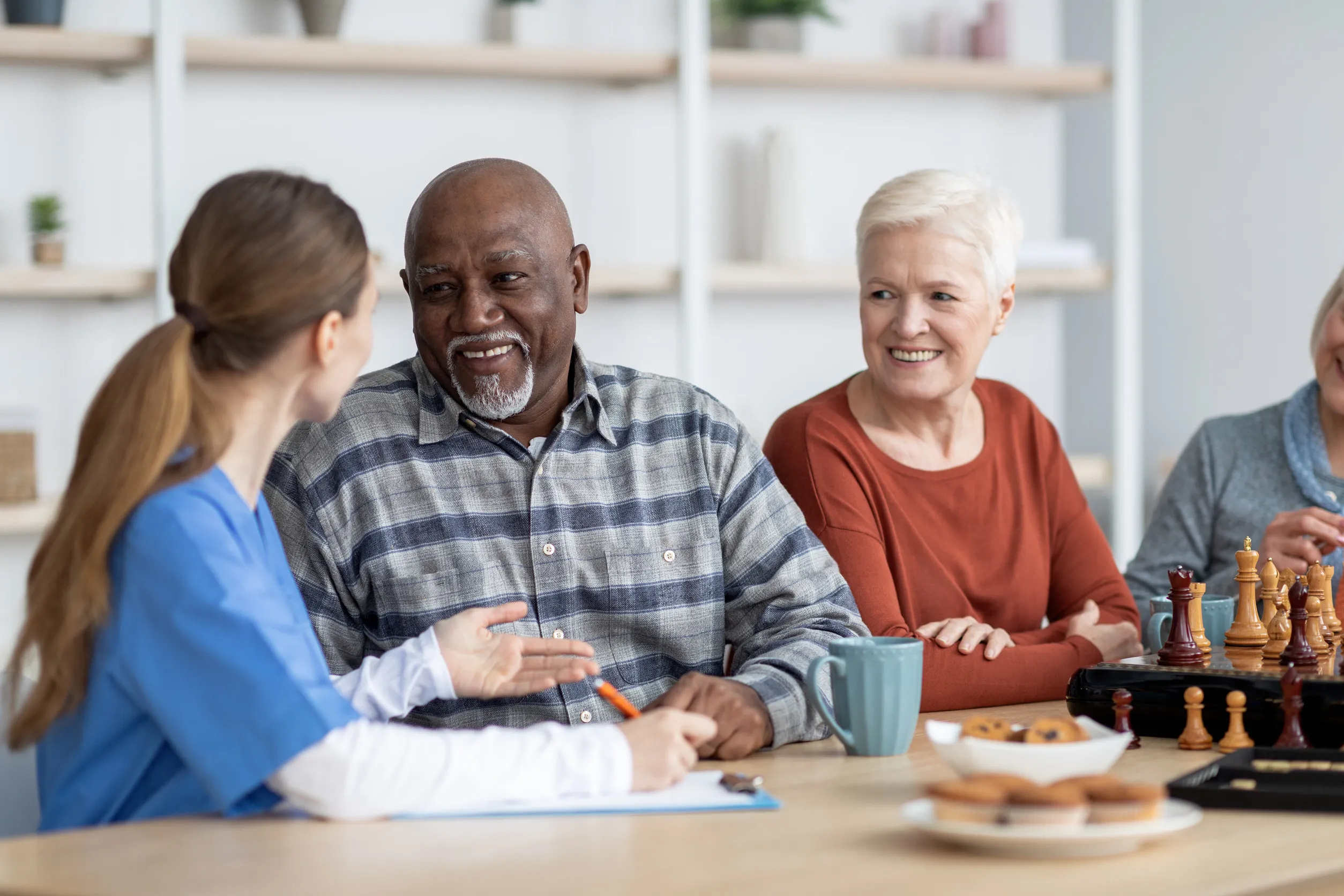 Nurse having conversation with african american senior man